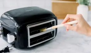 Use a toothbrush to clean hard-to-reach areas toaster